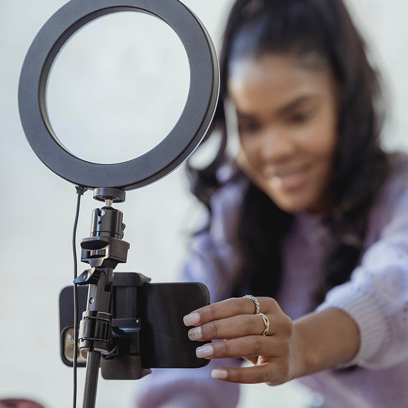 Woman with light ring and phone